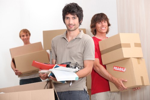 Local movers wrapping and loading household furniture for transport
