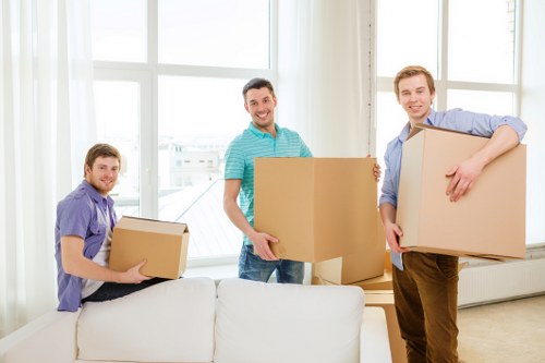 Professional movers navigating a central London property staircase