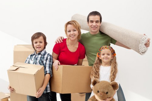 Professional movers wearing PPE while transporting household items